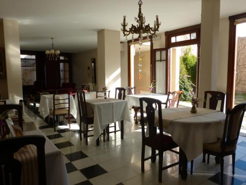 a dining room with tables and chairs and a chandelier at Nuevos Horizontes in Tandil