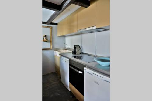 a kitchen with a sink and a counter top at Casa do Moinho de Vento in Leça da Palmeira