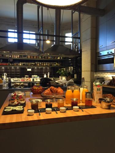 a kitchen with some food on a wooden table at Château La Thuilière in Saint-Front-de-Pradoux