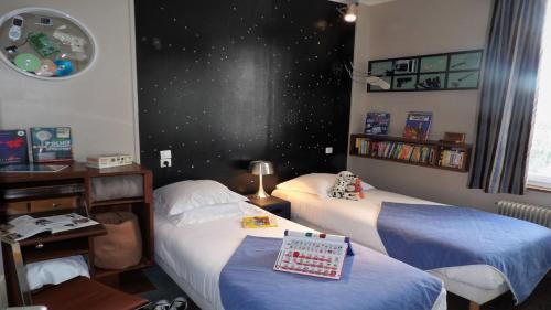 a room with two beds and a wall with stars at Detective Hotel in Étretat