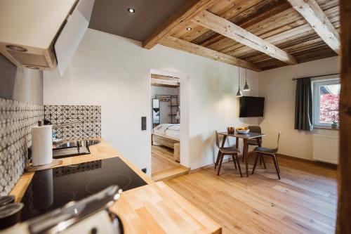 a kitchen and living room with a bed and a table at Gästehaus Richter in Grainau