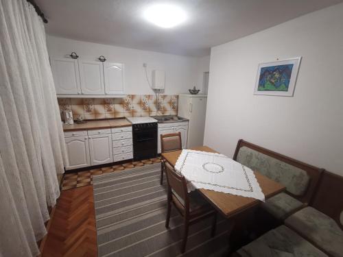 a small kitchen with a table and a table and a kitchen at Apartment Dino in Novi Vinodolski