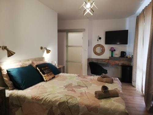 a bedroom with a bed with two stuffed animals on it at Riviera Rooms and Apartments in Rab