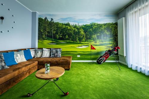 a living room with a painting of a golf course at The Golfer Apartment with Jacuzzi in Cluj-Napoca