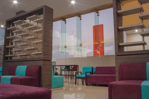 a room with purple and blue chairs and a table at Hotel Kavia Monterrey in Monterrey