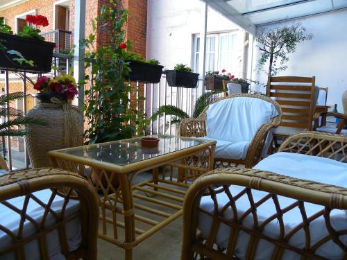 a patio with a table and chairs and flowers at Hôtel Poussin in Paris