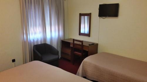 Un pat sau paturi într-o cameră la Hotel S. Gabriel