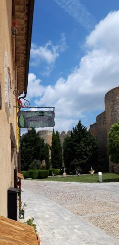a building with a sign on the side of a street at Pozolico Hotel Rural in Urueña
