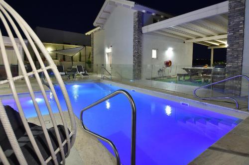 a swimming pool with a blue pool at הקצה- The Edge in Sifsufa