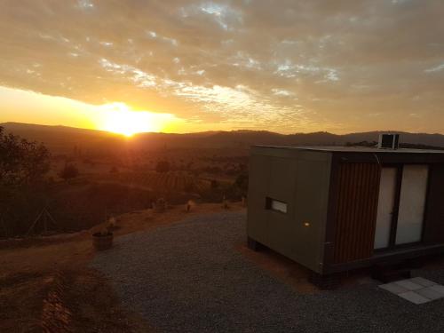a house on a hill with the sunset in the background at Echazarreta Vineyards in Casablanca