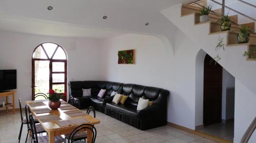 a living room with a black couch and a table at Casa Victoria in Nufăru