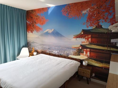 a bedroom with a wall mural of a mountain at Geniet van de zee met dit top-appartement Fuji Ostend in Ostend