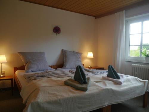 a bedroom with a large bed with two pillows on it at Im Alten Bahnhof in Bergen