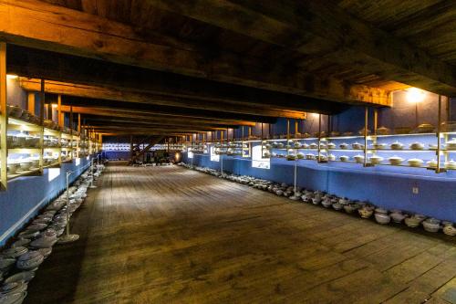 a large barn with a long aisle with animals at Penzion Kozí farma Nový Dvůr in Česká Lípa