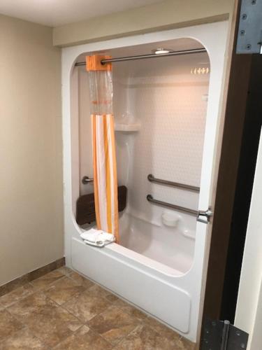 a bathroom with a shower with a toilet in it at La Quinta by Wyndham Columbus - Grove City in Grove City
