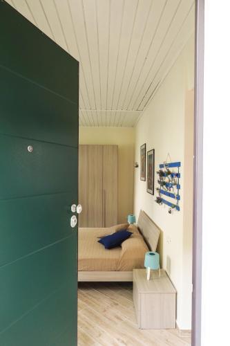 a bedroom with a bed with a green door at Rivacanze Apartments in Laglio