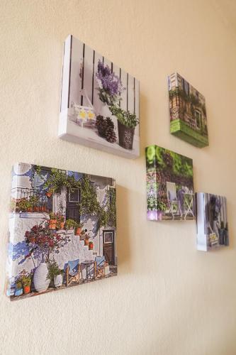 a group of pictures hanging on a wall at Rivacanze Apartments in Laglio