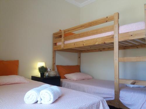 two beds in a room with two bunk beds at Las Arenas 112 - Atico vista al mar in Isla Canela