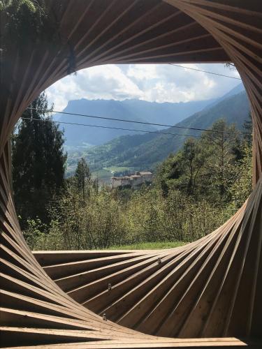 a hammock with a view of a mountain at Suite Romantica Fuga in Roncone