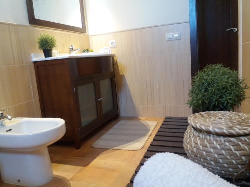 a bathroom with a sink and a toilet at Las Arenas 112 - Atico vista al mar in Isla Canela