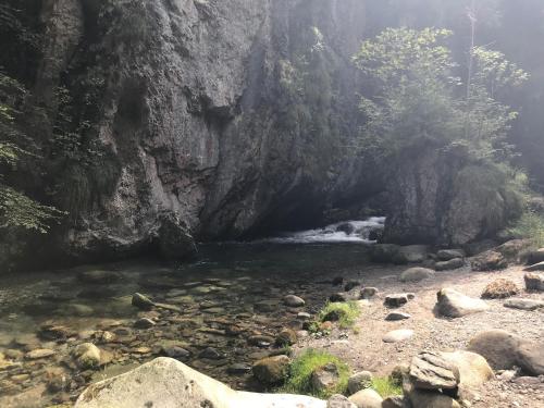 a river with rocks in front of a mountain at Casa Willigio in Roncone