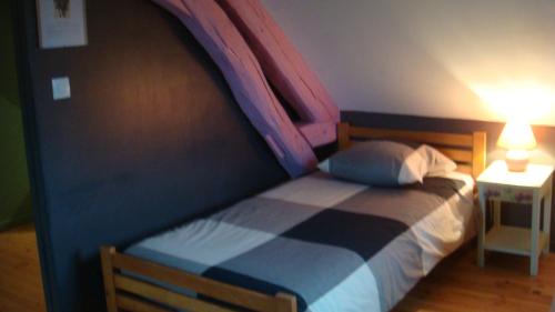 a bedroom with a bed with a canopy over it at Les Gallerands in Bessais-le-Fromental