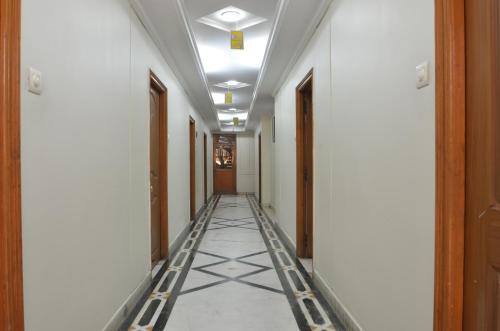 a hallway of a building with a tile floor at Hotel Annapoorna Residency in Hyderabad