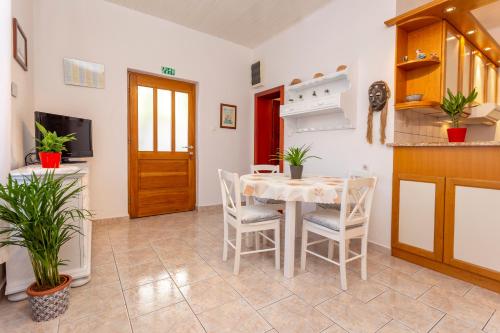 a kitchen and dining room with a table and chairs at Historic center Hvar town- a few steps from the main square in Hvar
