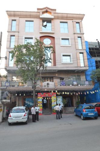 a large building with cars parked in front of it at Hotel Annapoorna Residency in Hyderabad