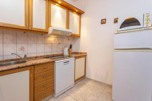 a small kitchen with a sink and a refrigerator at Historic center Hvar town- a few steps from the main square in Hvar