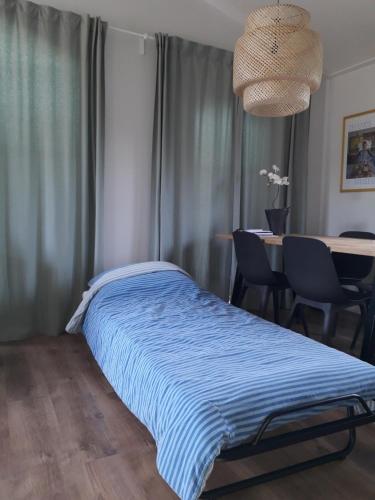 a bedroom with a bed and a table with chairs at De Krukel in Sint Annaland