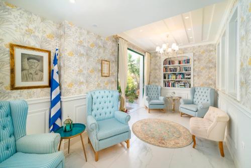 a living room with blue chairs and a table at Orion Hotel in Nydri
