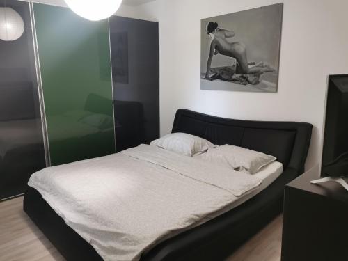 a bedroom with a bed and a woman sitting on a motorcycle at House Katarina in Ankaran