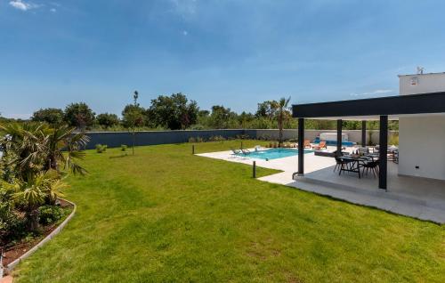 a yard with a pool and a pavilion at Villa Eni Medulin Sisan heated pool in Šišan