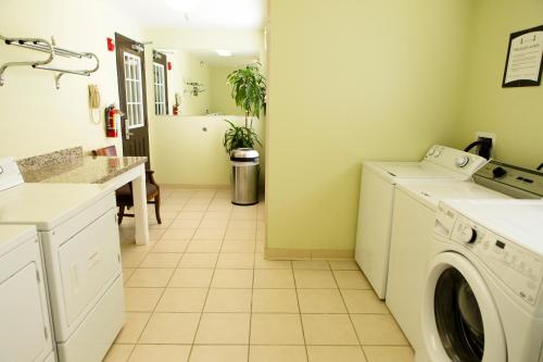 a laundry room with a washer and dryer at Staybridge Suites Silicon Valley - Milpitas by IHG in Milpitas