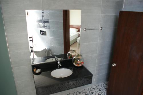 a bathroom with a sink and a mirror at Kemer Hotel in Kemer