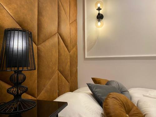 a room with a bed and a lamp on a table at Family & Business Sauna Apartments No 6 Leśny nad Zalewem Cedzyna - 1 Bedroom with Private Sauna, Terrace, Parking, Catering Options in Kielce