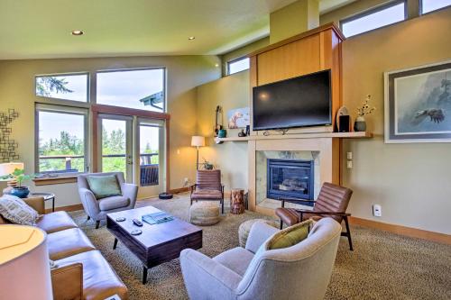a living room with a fireplace and a tv at Luxe Coastal Haven with Bay Views and Hot Tub in Bay City