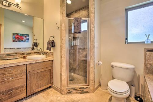 a bathroom with a shower and a toilet and a sink at Luxe Coastal Haven with Bay Views and Hot Tub in Bay City