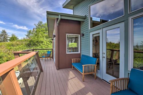 a house with a deck with blue chairs on it at Luxe Coastal Haven with Bay Views and Hot Tub in Bay City