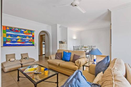 a living room with two couches and a table at Villa White Sands - Private Oasis, Heated Pool, Beaches & Strip Nearby in Albufeira