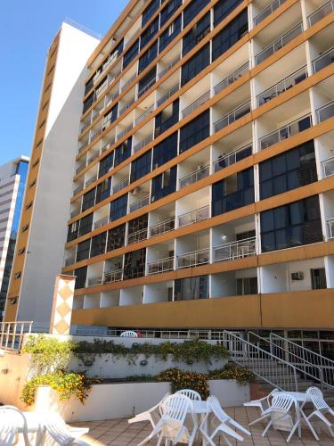 a large building with white chairs in front of it at Garvey Flats in Brasilia
