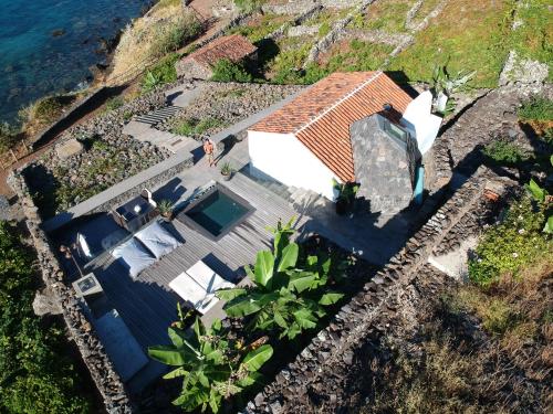 an aerial view of a house next to the water at Vigia da Areia in São Lourenço