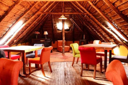 a room with tables and chairs in a cabin at Hacienda El Porvenir by Tierra del Volcan in Machachi
