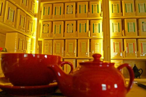 a red tea pot and a bowl on a table at Haus Alpenfriede in Ramsau im Zillertal