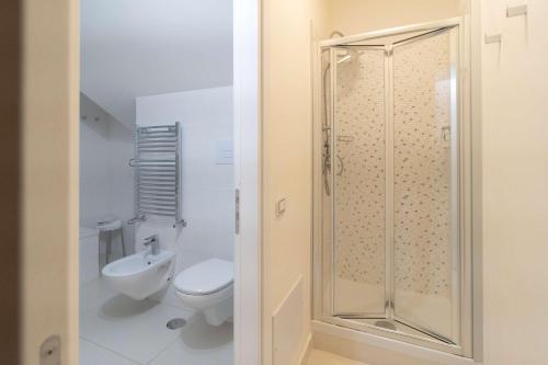 a white bathroom with a shower and a toilet at Best Western Plus Hotel Perla Del Porto in Catanzaro Lido