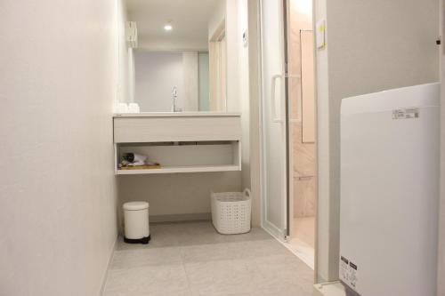 a kitchen with a white refrigerator in a room at Hotel Flap Resort in Chatan