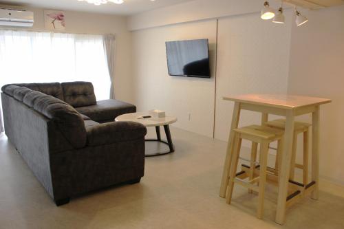 a living room with a couch and a table at Hotel Flap Resort in Chatan