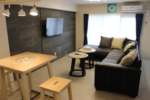 a living room with a couch and a table at Hotel Flap Resort in Chatan