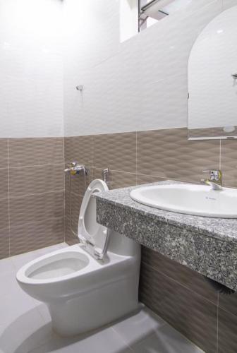 a bathroom with a toilet and a sink at MrLee Dalat House in Da Lat